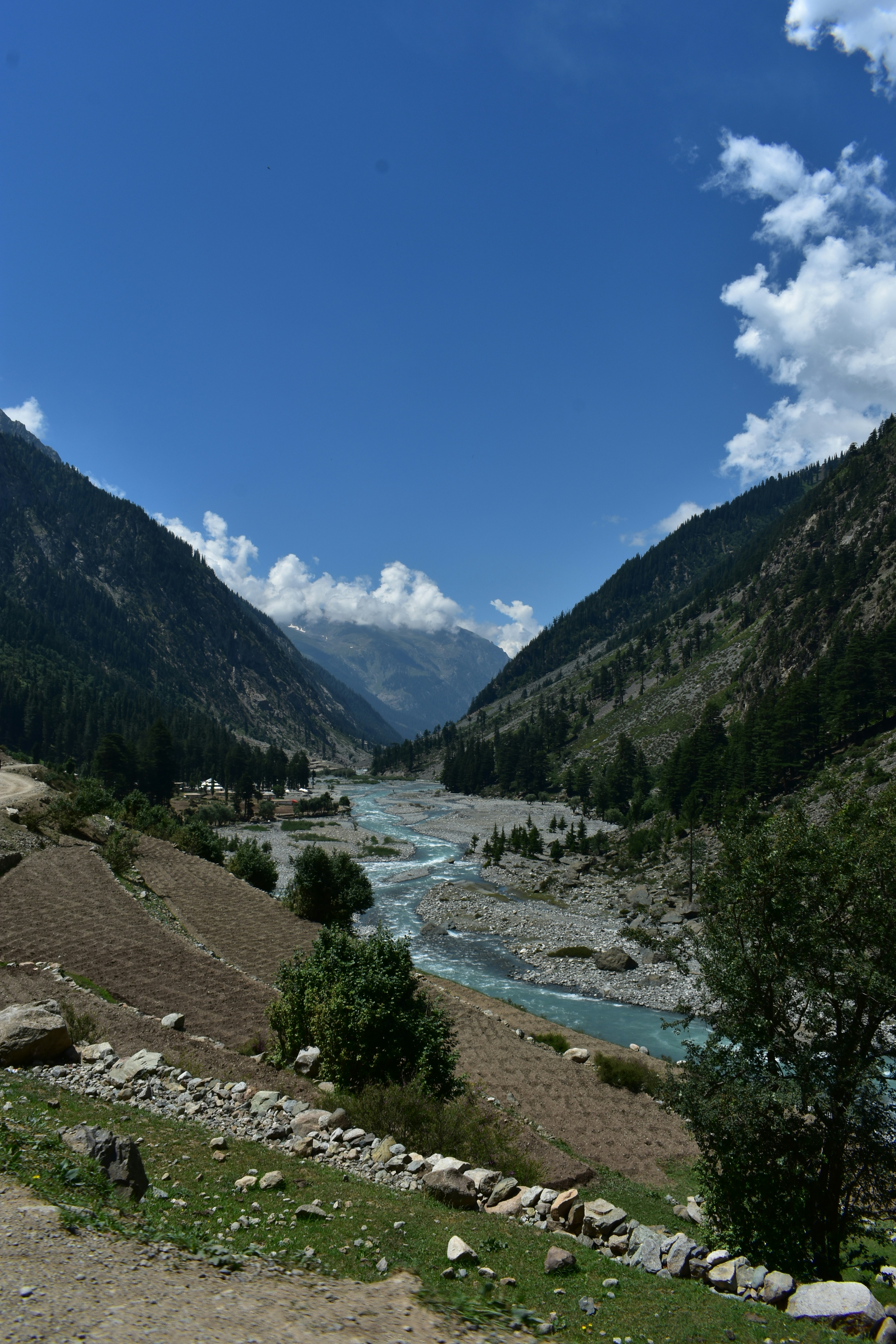 A panoramic shot of a valley with a clear blue sky.